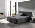 Grijs hoeslaken op een splittopper van een boxspring met antraciet hoofdbord, één helft omhoog gesteld