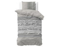 Grijs dekbedovertrek met tekstprint Residence De Luxe en Calm Rustic Feeling, met bijpassende kussensloop op een bed