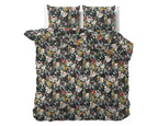 Zwart dekbedovertrek met kleurrijke bloemenprint op een bed, met twee bijpassende kussens