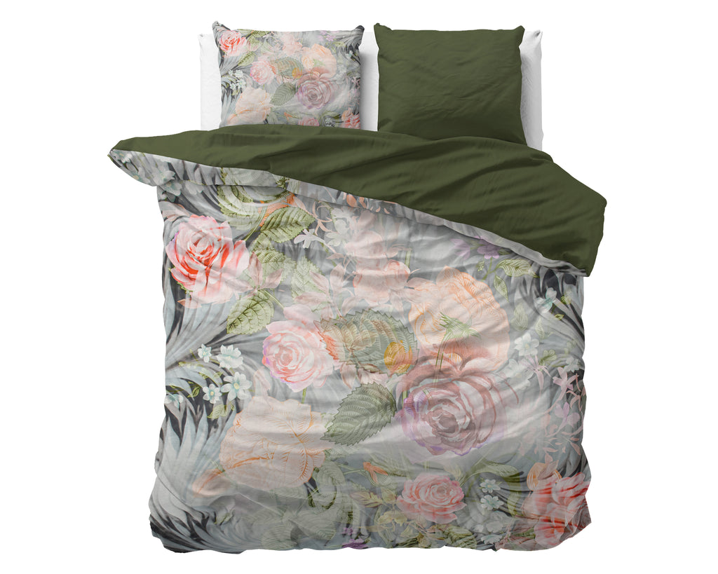 Dekbedovertrek met bloemenprint van rozen en bladeren, omgeslagen met effen onderzijde, met twee kussens op een bed