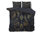 Opgemaakt bed met blauw dekbedovertrek met gouden paisleyprint, twee kussens en een effen donkere omgeslagen onderzijde