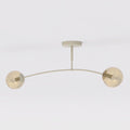 Beige plafondlamp met gebogen frame en twee amberkleurige glazen bollen
