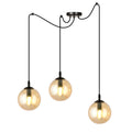Zwarte hanglamp met drie amberkleurige glazen bollen aan zwarte snoeren en een ronde plafondplaat