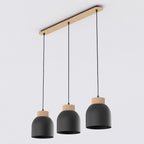Zwarte hanglamp met drie koepelvormige kappen met houten top, opgehangen aan een langwerpige houten plafondbalk