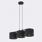 Zwarte hanglamp met drie cilindrische stoffen kappen met geperforeerd patroon, aan een zwarte balk met twee dunne stangen