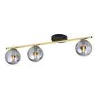Plafondlamp met gouden buis, zwarte plafondplaat en drie grafietkleurige glazen bollen op een rij