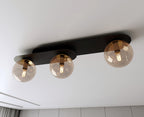 Plafondlamp gepoedercoat staal en glas Plaza, zwart met amberkleurige kappen, 3 lichtpunten, 70 x 18 cm
