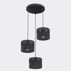 Zwarte hanglamp met drie stoffen kappen aan een ronde zwarte plafondplaat
