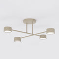 Beige plafondlamp met kruisarm en vier ronde lampen met witte diffusers, tegen een lichte achtergrond