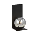Zwarte wandlamp met hoekige stalen plaat en ronde glazen kap in grafiet met spiegelend effect