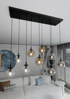 Hanglamp gepoedercoat staal en glas Cosmo zwart, 9 glazen kappen transparant, grafiet en amber, 104 x 120 cm