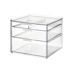 Transparante make-up organizer met drie lades met witte handgrepen en een tray bovenop