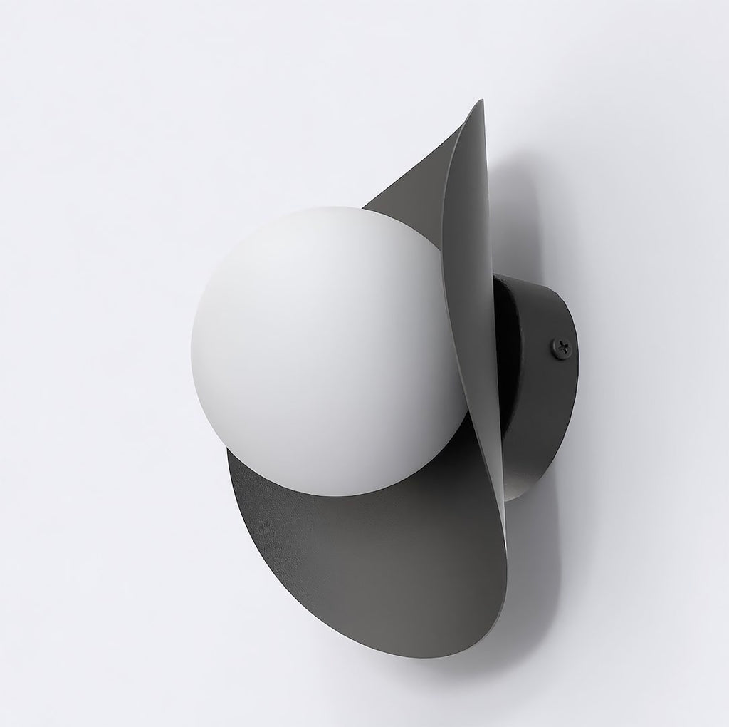 Zwarte wandlamp met lintvormige metalen kap en een witte bol aan een lichte wand